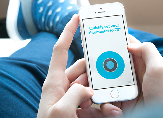 A person uses Do Button on their iPhone to set their Nest Thermostat to seventy degrees.